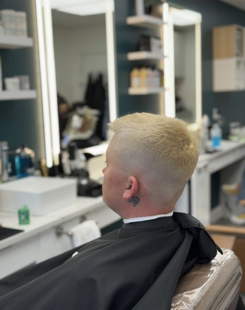 Cropped platinum blonde fade haircut, back view