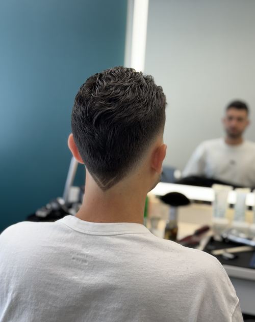Barber giving a skin fade haircut at The Pros Salon